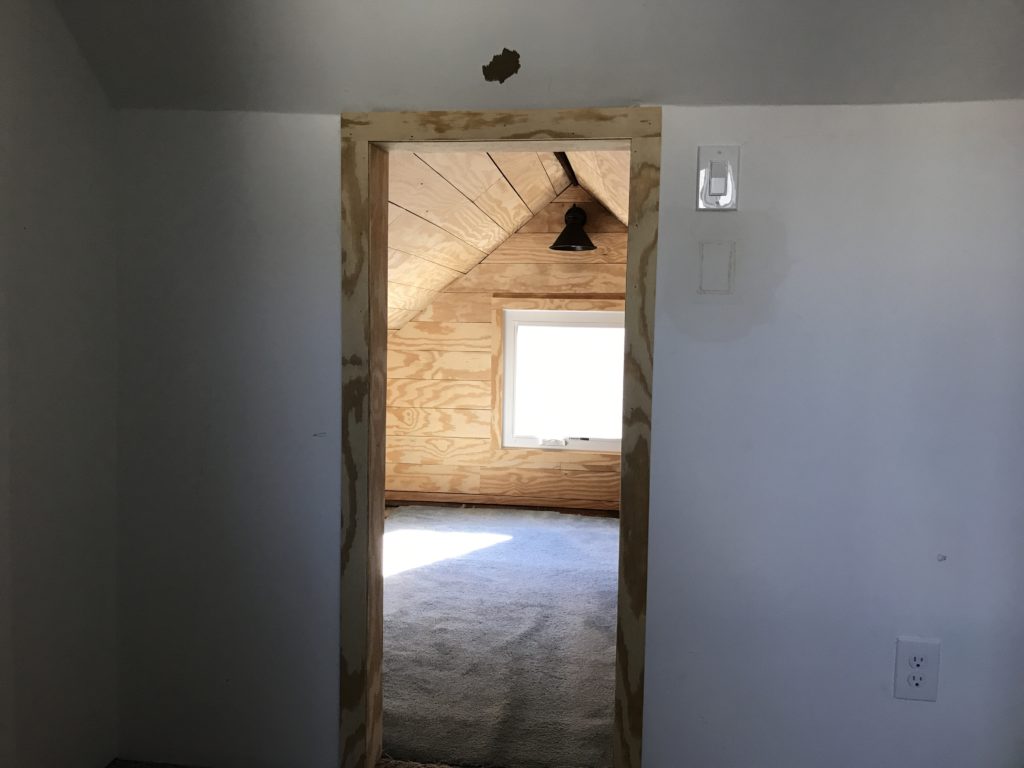 Faux shiplap with plywood. Attic play room. Oil rubbed bronze rustic farmhouse light. Rustic plywood trim.