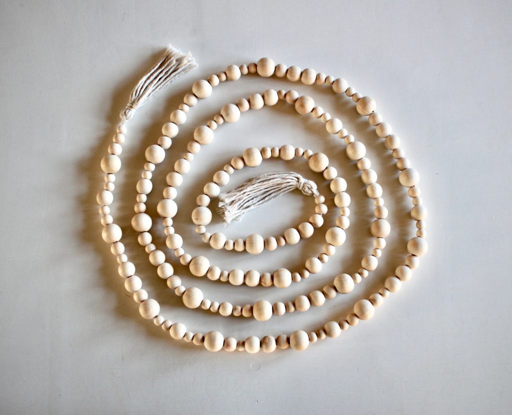 Simple wood bead garland with tassels for creating a minimalist Scandinavian Christmas.