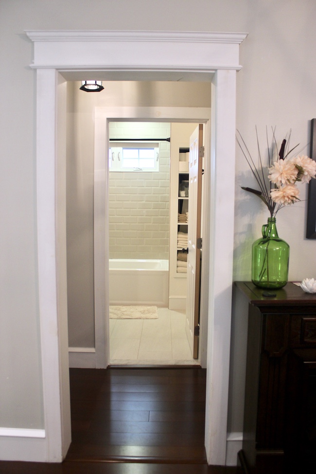 Bathroom remodel with built in storage shelves next to the shower.