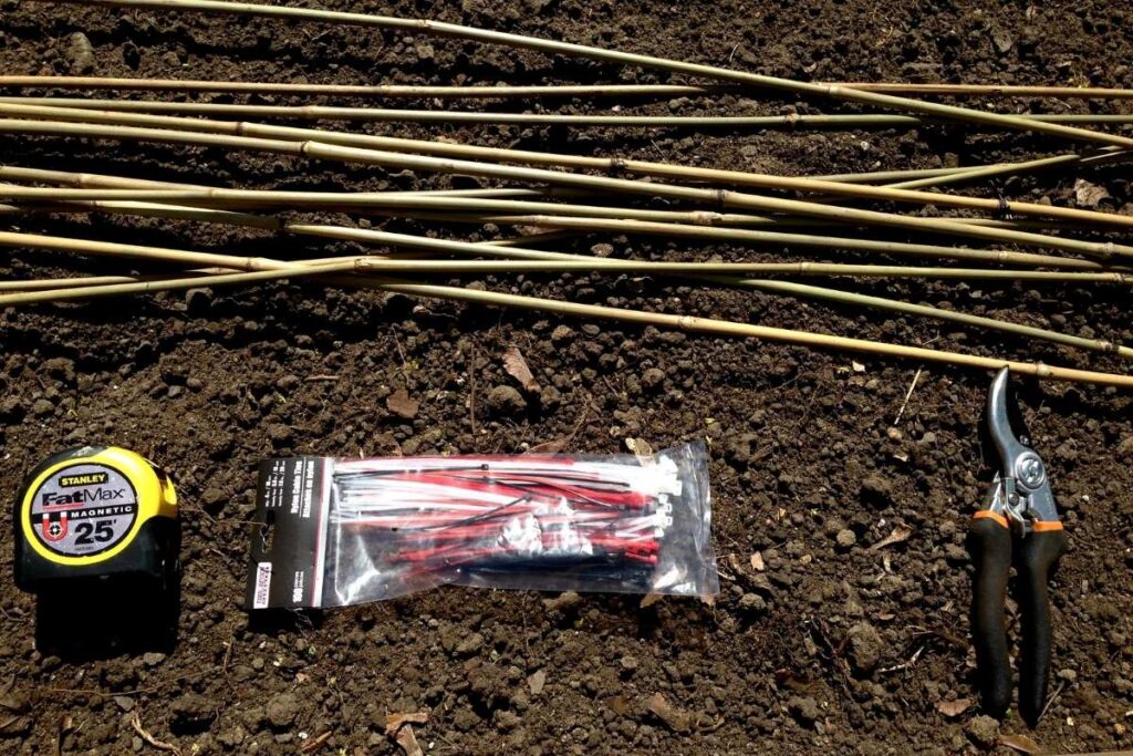 Supplies to make square foot garden grid: bamboo stakes, tape measure, zip ties and pruning shears 
