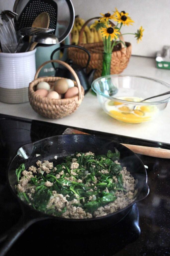 Turkey sausage and cooked spinach. 