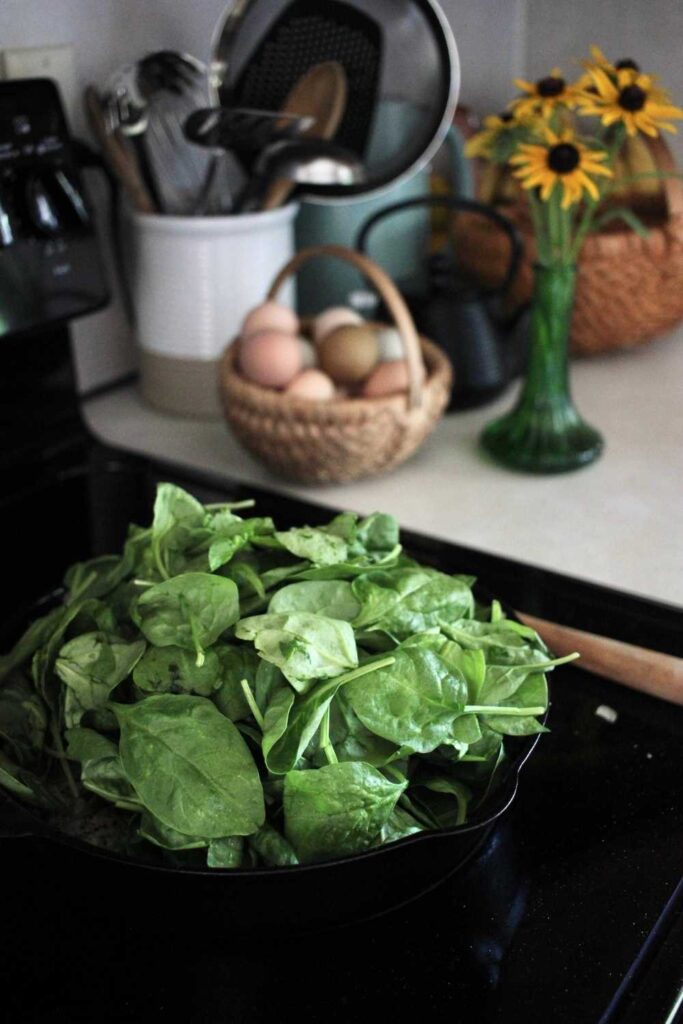 Fresh spinach in a cast iron skillet.