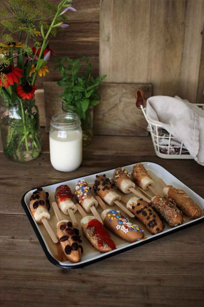 a beautiful display of banana peanut butter popsicles arranged on a tray ready to be frozen