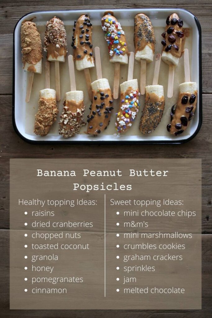 twelve frozen banana peanut butter popsicles laying on a tray with a list of healthy and sweet topping ideas