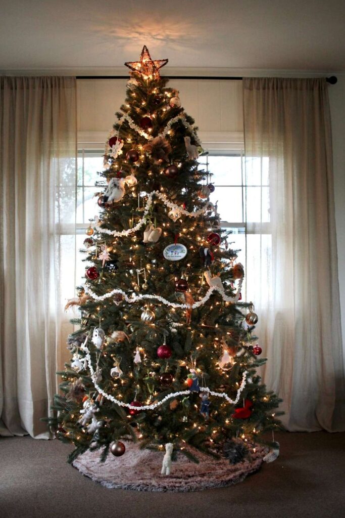 A simple and special Christmas tree decorated in a variety of quality heirloom ornaments with popcorn garden.