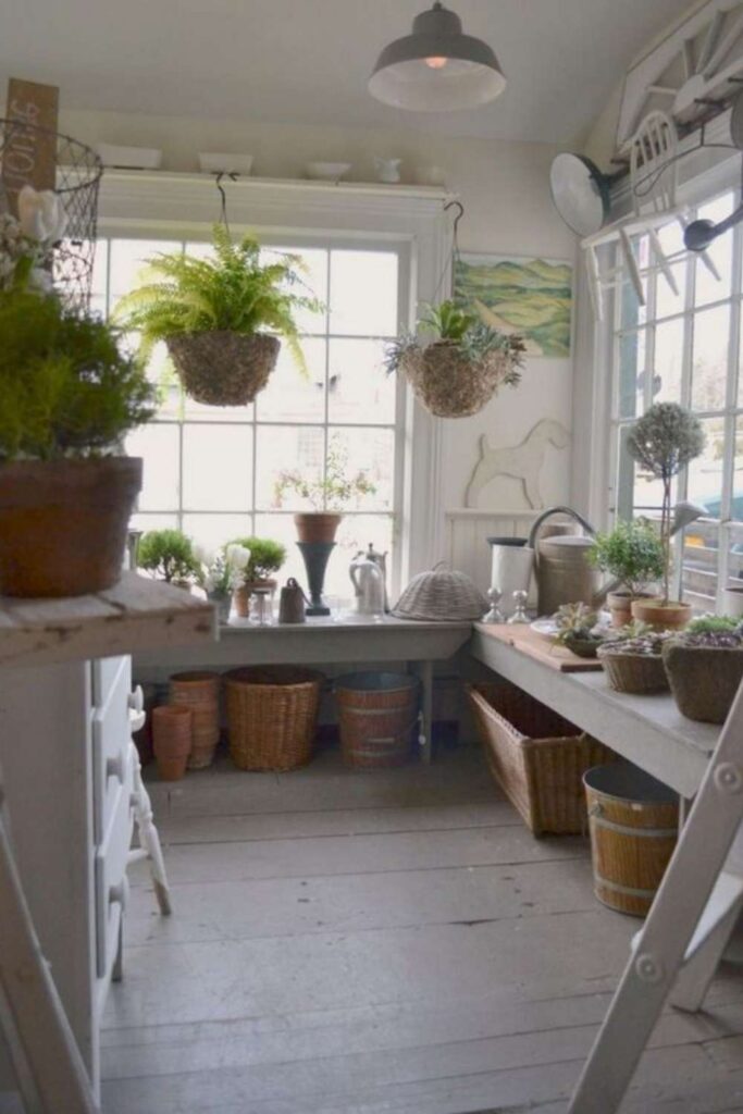 Inspiring garden shed ideas - large windows, potting benches, hooks for hanging plants and tools.