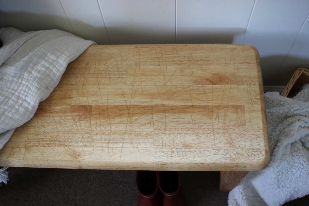 A picture showing the top of the wood bench finished in tung oil. Showing how the oil brings out the scratch marks.