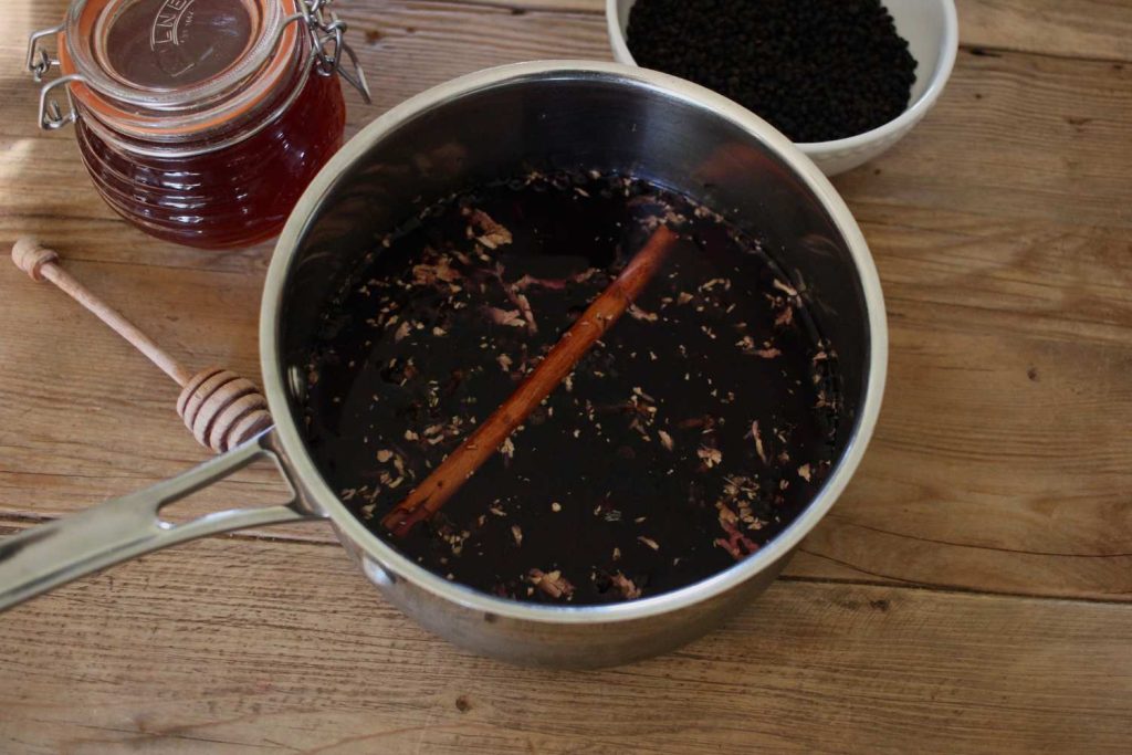 how to make elderberry syrup step 1 - place all ingredients into pot except honey