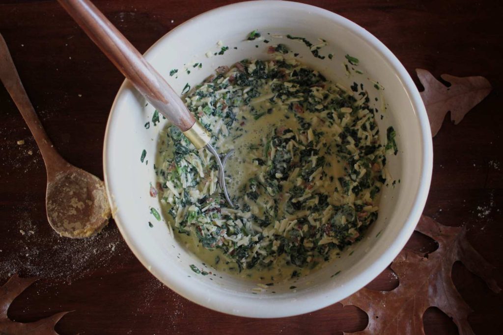 Quiche batter mixed together in a large stoneware bowl.